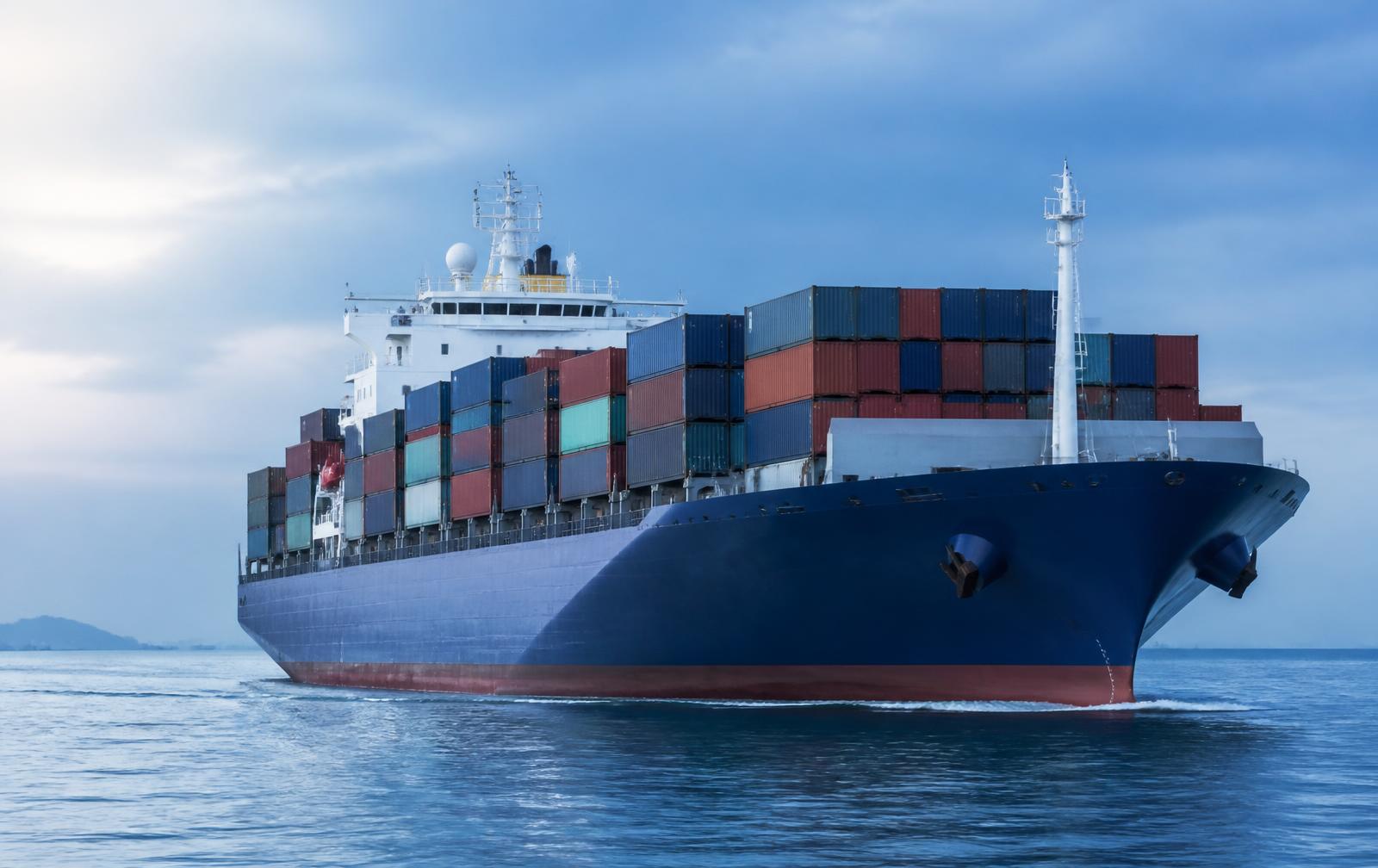 Commercial container vessel at sea with a satellite dome antenna on the superstructure