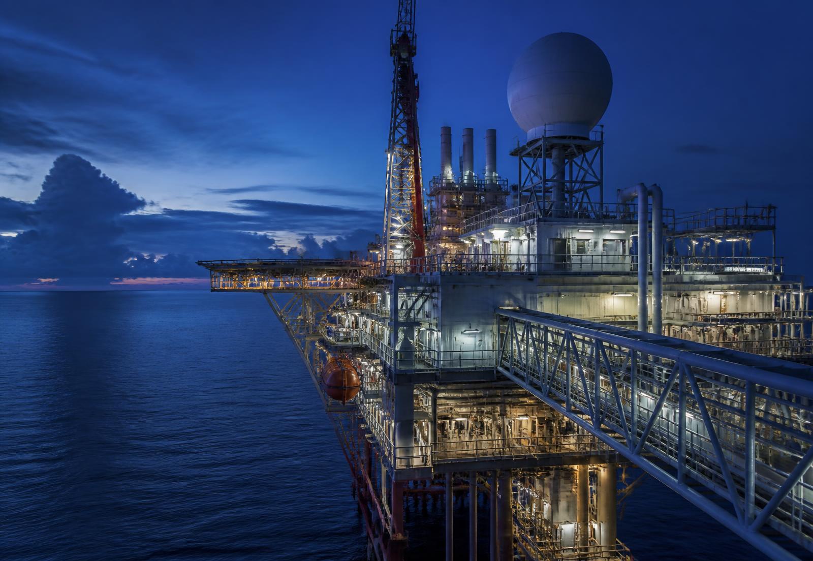 Offshore platform at dusk with a satellite communications radome