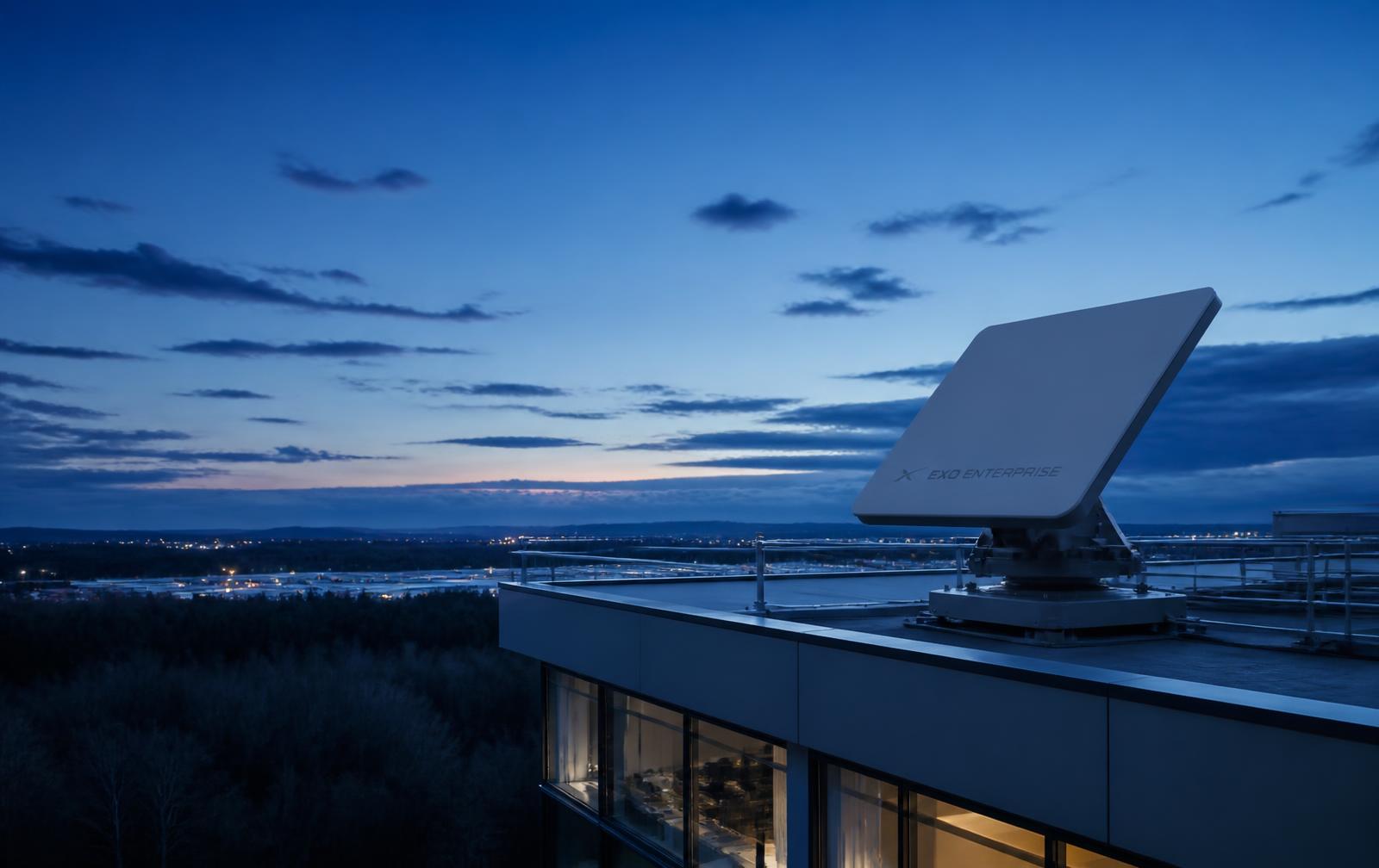 Enterprise LEO satellite terminal installed on a corporate facility rooftop at blue hour
